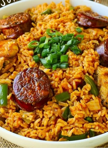 A bowl of Authentic New Orleans Creole Jambalaya with shrimp, sausage, and vibrant spices.