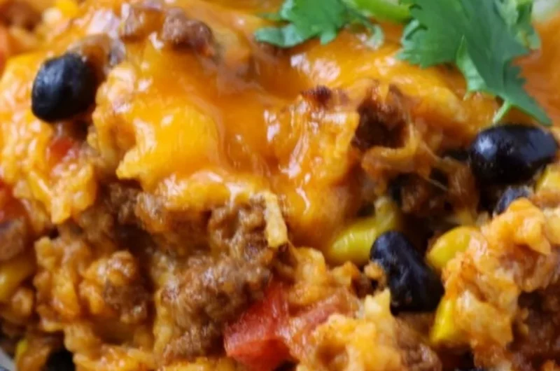 Savory beef enchilada casserole layered with rice and topped with cheese