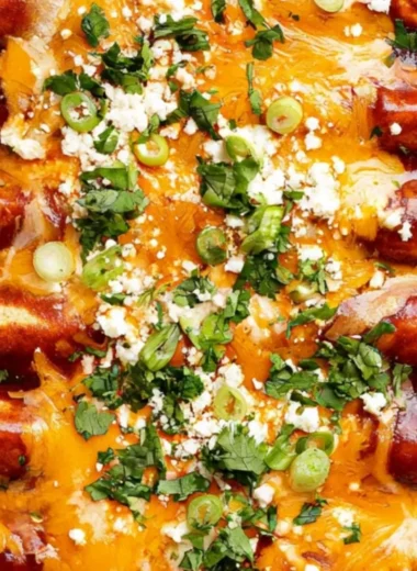 Cozy black bean enchiladas topped with cheese and served with salsa