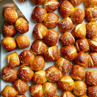 Cozy homemade pretzel bites served with dipping sauce in a warm setting.