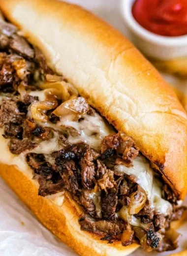 Delicious homemade Philly cheesesteak served on a toasted bun with melted cheese