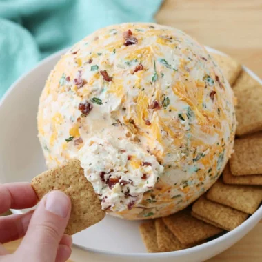 Easy cheese ball served with crackers and veggies on a platter