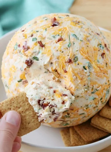 Easy cheese ball served with crackers and veggies on a platter