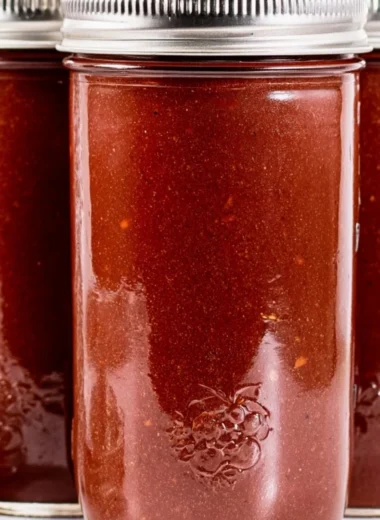 Homemade BBQ sauce in a jar with fresh ingredients