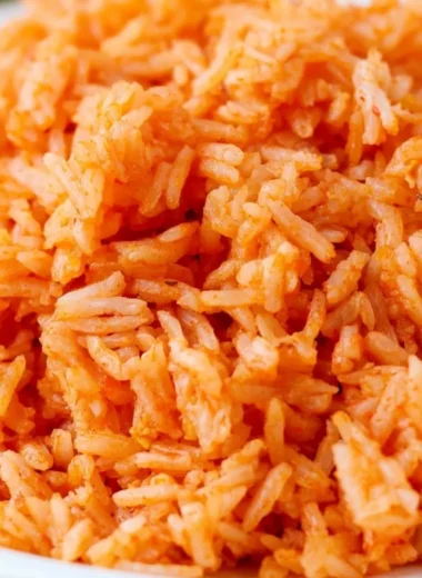 Plate of quick and easy Spanish rice with fresh herbs and spices.