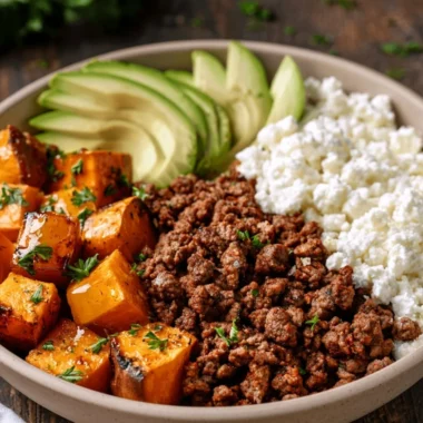 Delicious hot honey sweet potato beef bowls topped with fresh herbs.
