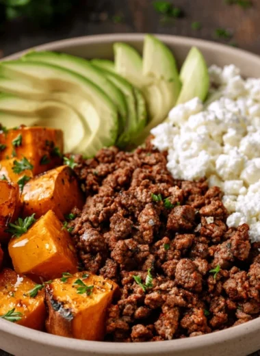 Delicious hot honey sweet potato beef bowls topped with fresh herbs.